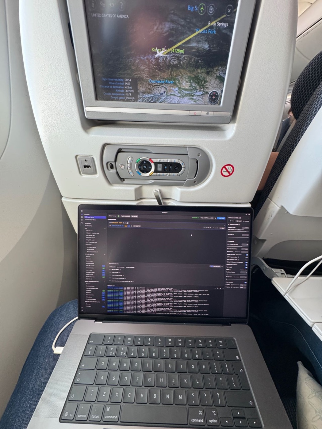 MacBook Pro M5 Max running LM Studio with Qwen loaded on a British Airways seat tray
